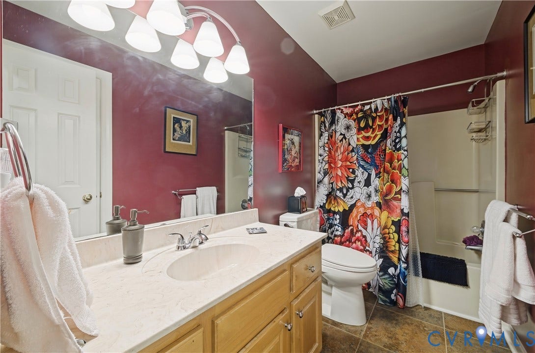 411 Hickory Drive, Manakin Sabot, VA 23103 Built-in vanity with light wood-finish cabinetry, a single basin sink, and a chrome faucet