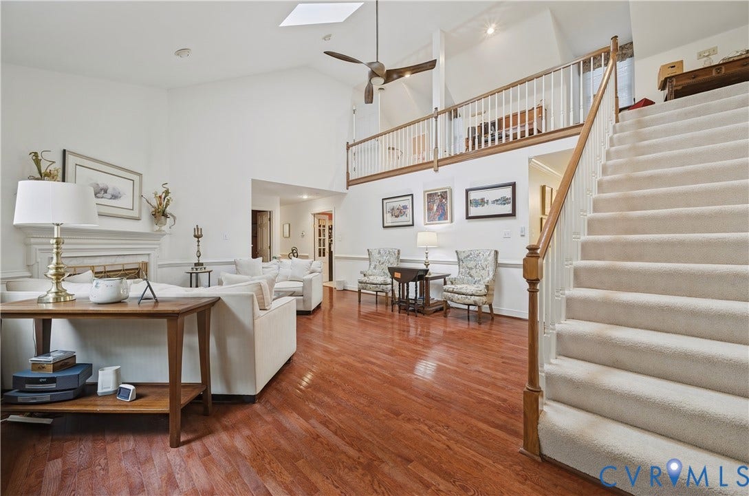 411 Hickory Drive, Manakin Sabot, VA 23103 Cathedral ceiling with a skylight, wood-finish flooring, a fireplace with a mantel, a ceiling fan, and a carpeted staircase with a wood handrail