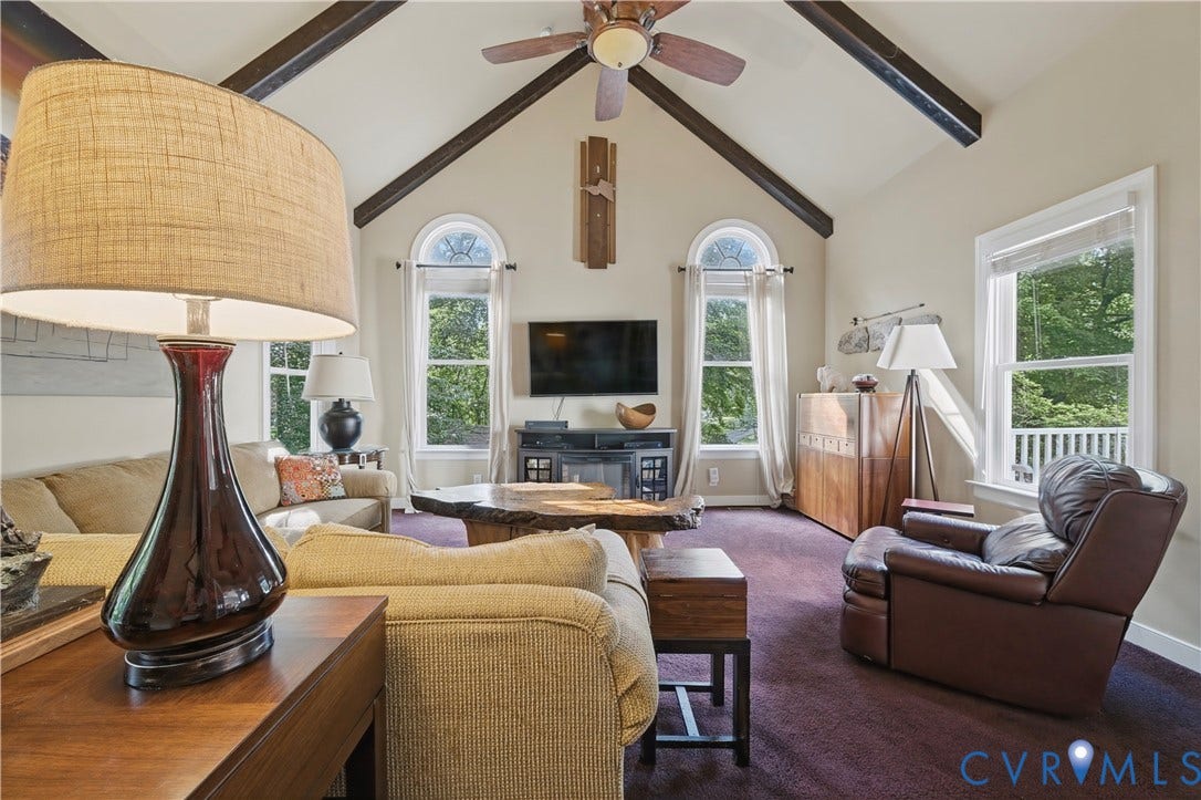 411 Hickory Drive, Manakin Sabot, VA 23103 Vaulted ceiling with exposed beams, ceiling fan, arched window, wood-finish console table, and carpeted flooring