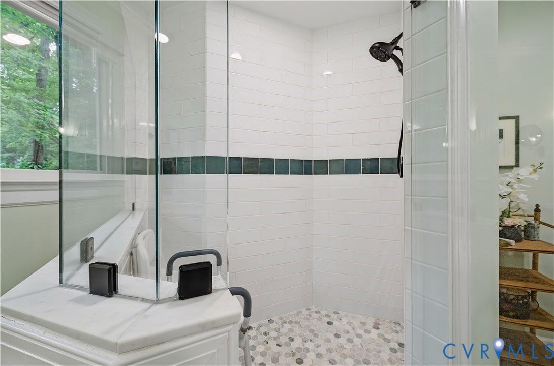 411 Hickory Drive, Manakin Sabot, VA 23103 Glass-enclosed shower with subway tile walls, a decorative tile accent band, a hex-tile shower floor, and a matte black shower head