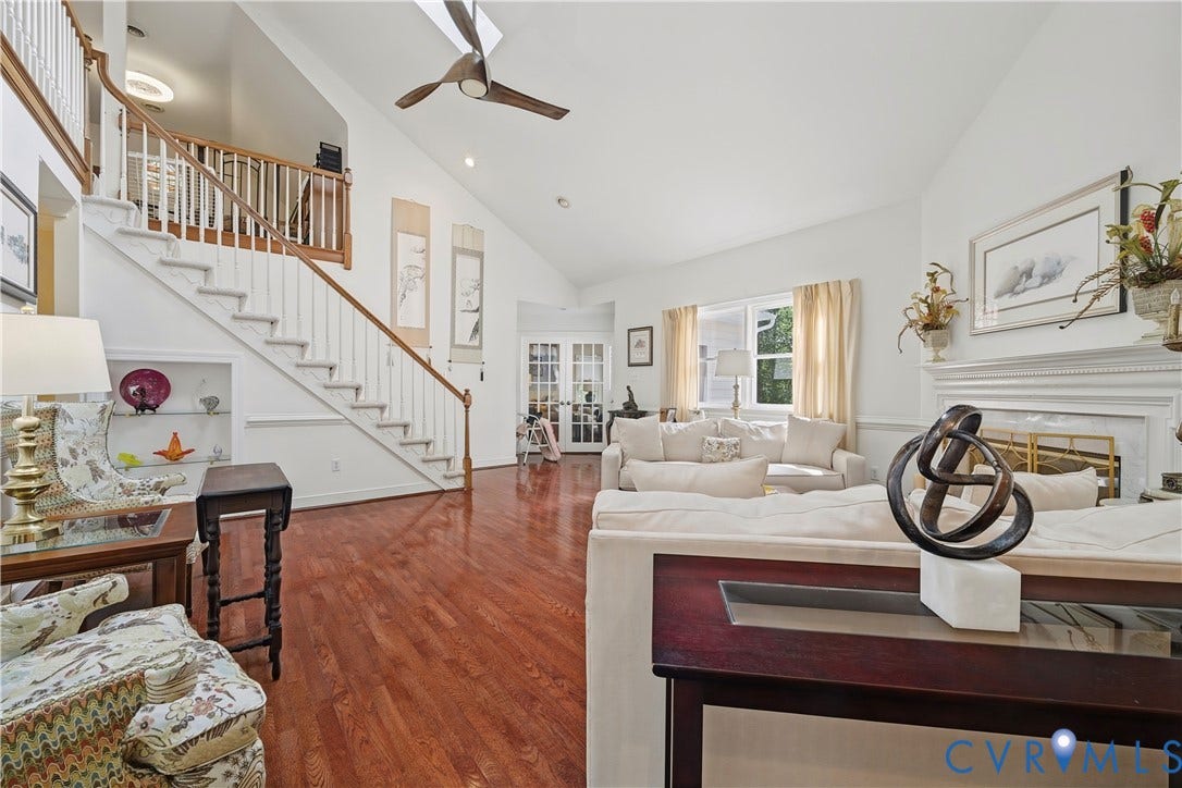 411 Hickory Drive, Manakin Sabot, VA 23103 Varnished wood flooring, built-in shelving, white painted staircase with wood handrail, vaulted ceiling, and dual French doors