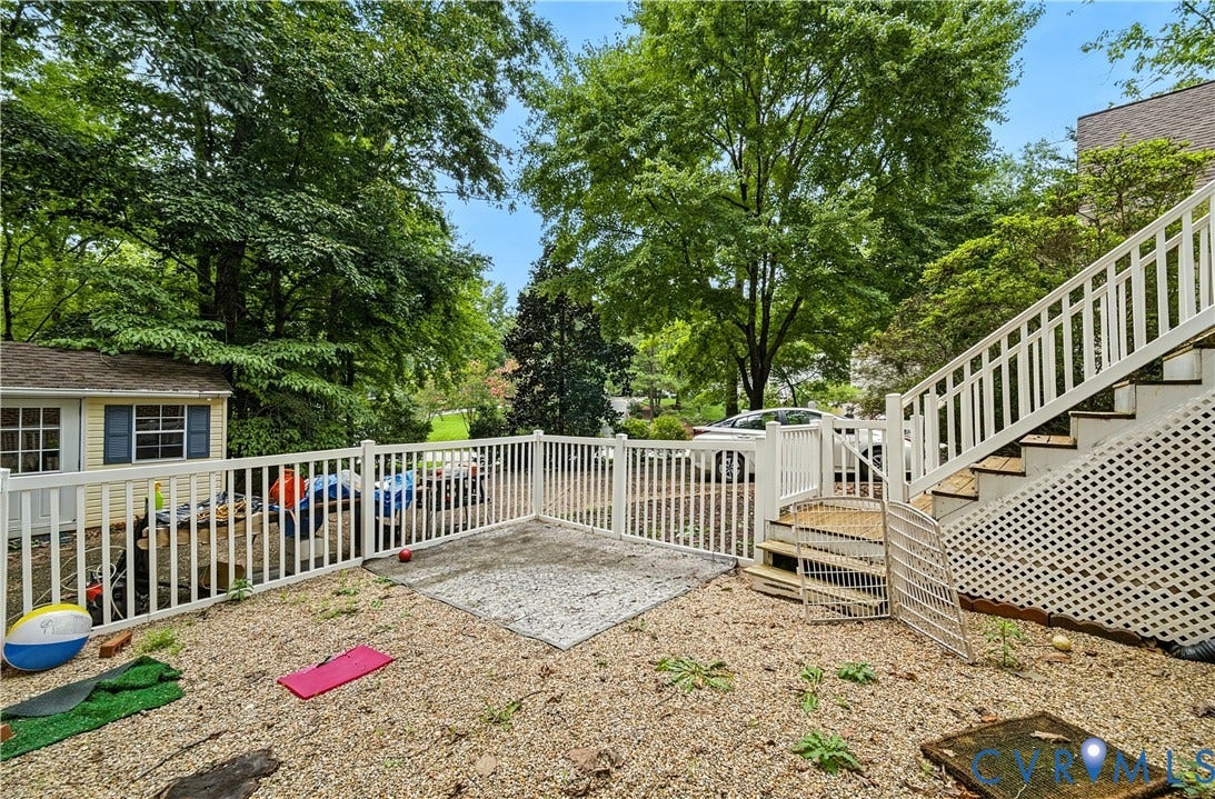 411 Hickory Drive, Manakin Sabot, VA 23103 Tiered landscaping with a gravel ground cover, white picket fencing, and a permanent shed structure