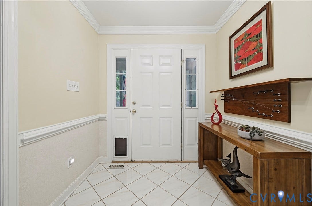 411 Hickory Drive, Manakin Sabot, VA 23103 Entryway featuring a white paneled door with sidelights, crown molding, chair rail molding, and diagonally laid tile flooring