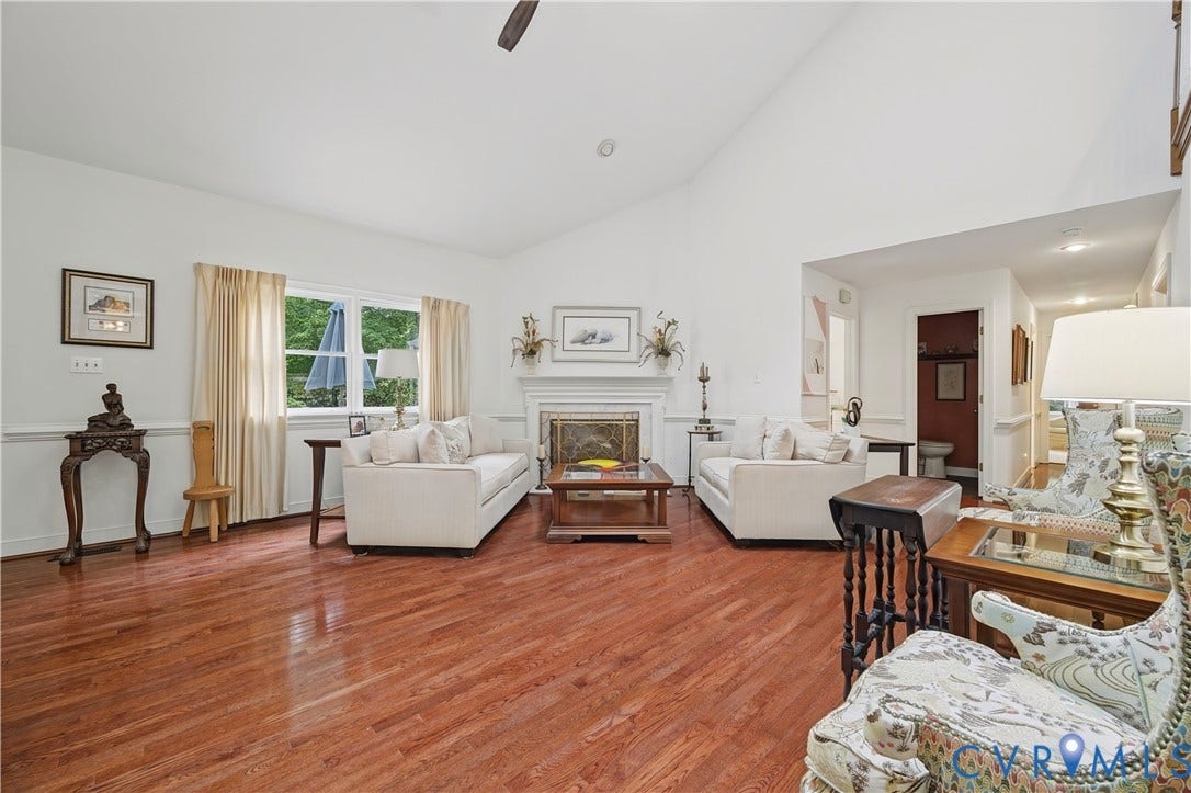 411 Hickory Drive, Manakin Sabot, VA 23103 Vaulted ceiling with an exposed beam, a fireplace with a decorative mantel, wood-finish flooring, and a large window with white trim