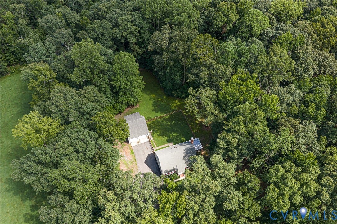 10478 Gould Hill Road, Studley, Hanover, VA 23069 Expansive property featuring the main residence, detached garage, a paved driveway, and substantial surrounding tree coverage