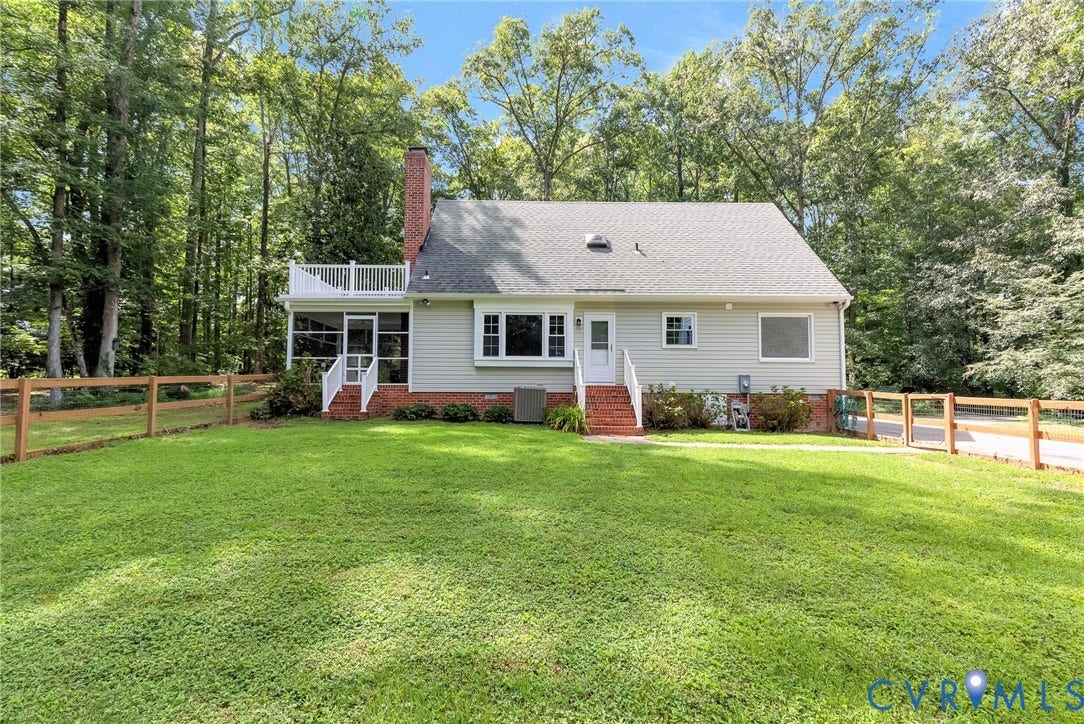 10478 Gould Hill Road, Studley, Hanover, VA 23069 Expansive green lawn with a wooden fence, featuring a screened porch and upper-level deck