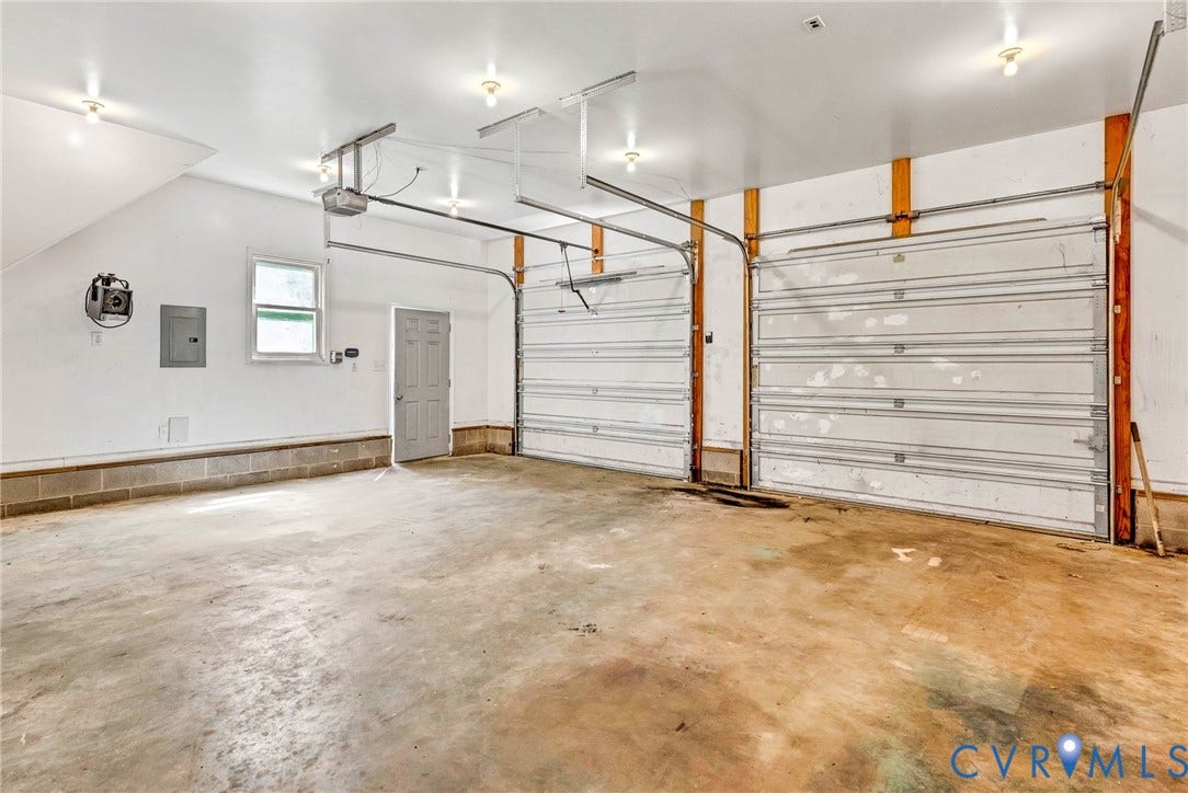 10478 Gould Hill Road, Studley, Hanover, VA 23069 Two-car garage with concrete flooring, two overhead garage doors, and built-in lighting. Featuring 10 ft ceilings and 240 current.