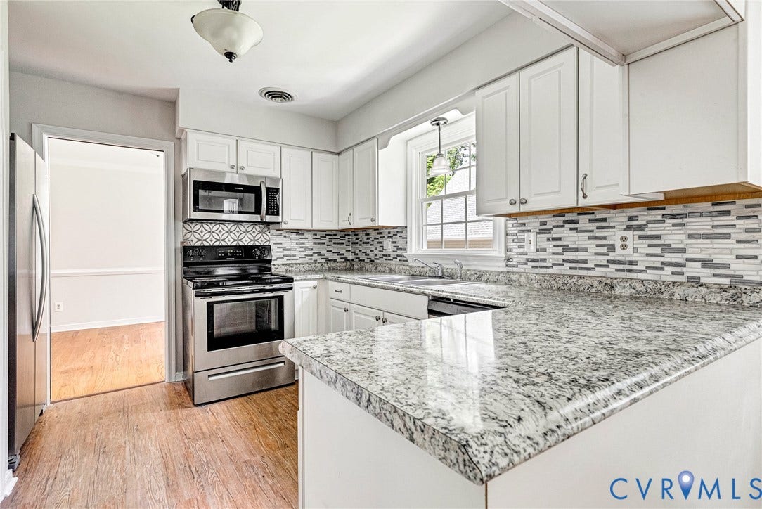 10478 Gould Hill Road, Studley, Hanover, VA 23069 White cabinetry, stainless steel appliances, mosaic tile backsplash, speckled countertops, and wood-finish flooring
Kitchen was update about 5 years ago