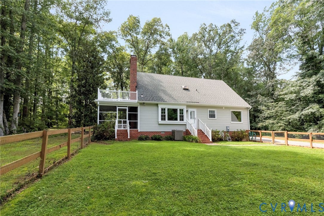 10478 Gould Hill Road, Studley, Hanover, VA 23069 Expansive backyard with a wooden fence, featuring a screened porch, an upper-level balcony, and a brick chimney