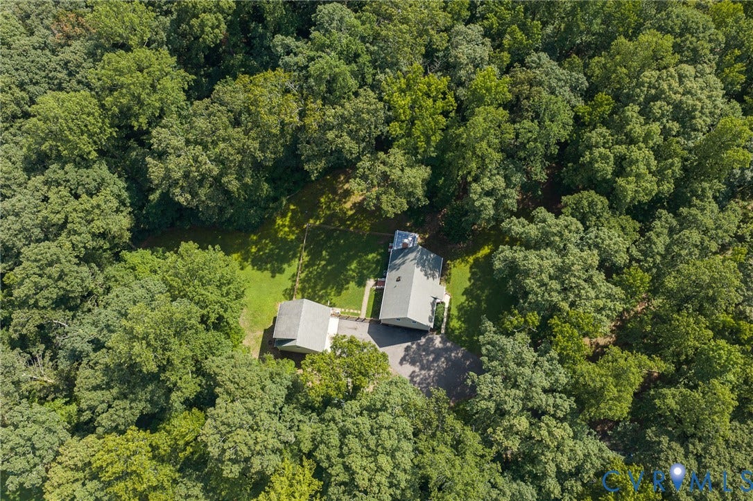 10478 Gould Hill Road, Studley, Hanover, VA 23069 Aerial perspective with expansive tree canopy, featuring a main residence, an auxiliary structure, and a paved driveway