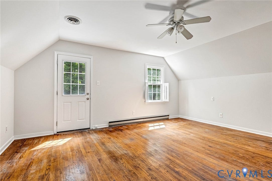 10478 Gould Hill Road, Studley, Hanover, VA 23069 Bedroom 2 with Vaulted ceiling featuring a ceiling fan, exposed wood-finish flooring, and natural light from a window and glass-panel door. Door leads to balcony over screen porch. Fresh paint