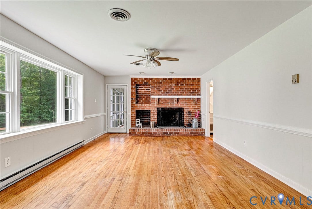 10478 Gould Hill Road, Studley, Hanover, VA 23069 Hardwood flooring throughout, brick fireplace with mantel, ceiling fan with light fixture, and multiple windows
Freshly painted