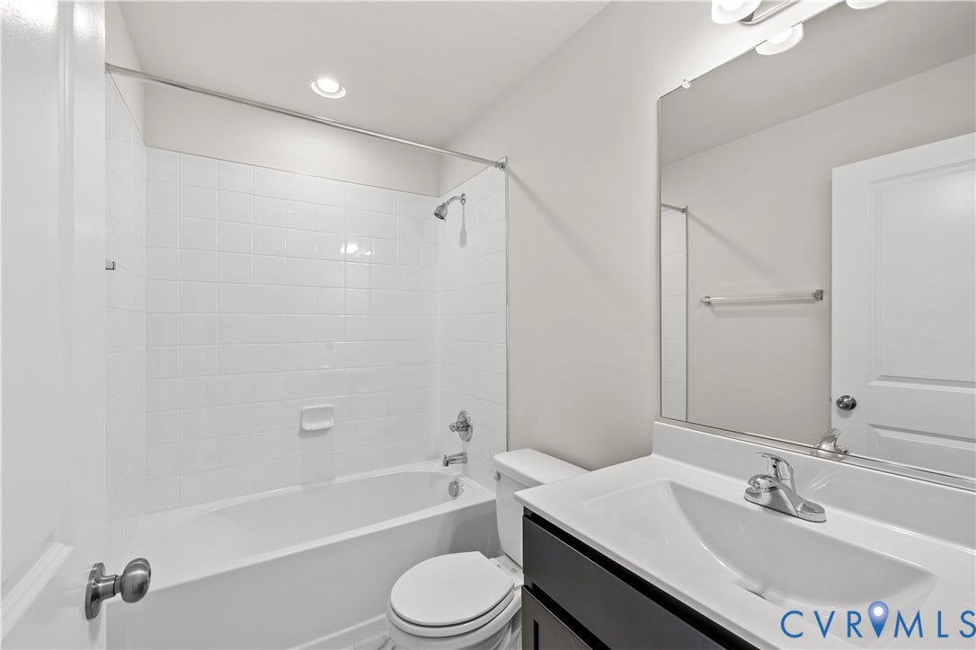 3372 Dewsberry Lane, Henrico, VA 23231 Bathroom featuring a white subway tile tub surround, recessed lighting, a single vanity with an integrated sink, and a chrome faucet