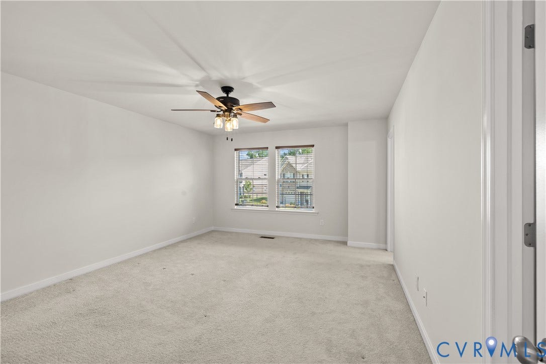 3372 Dewsberry Lane, Henrico, VA 23231 Neutral tone wall finishes, carpeting, ceiling fan with light kit, and natural light from a double window