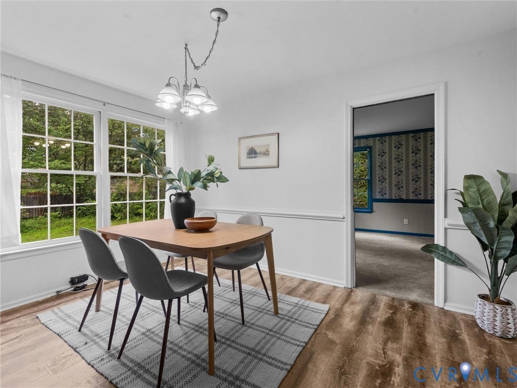 3610 Castlebury Drive, Chester, VA 23831 Wood-finish flooring, white walls, large multi-pane windows, and a chandelier with white shades