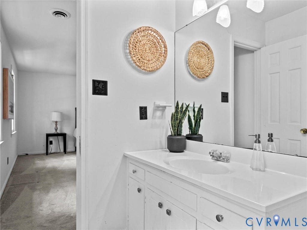 3610 Castlebury Drive, Chester, VA 23831 White vanity with integrated sink, chrome faucet, and framed mirror