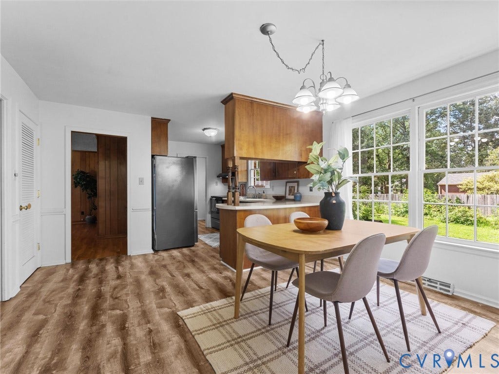3610 Castlebury Drive, Chester, VA 23831 Wood-finish flooring, white walls with wainscoting, wood cabinetry, stainless steel refrigerator, and a multi-pane window