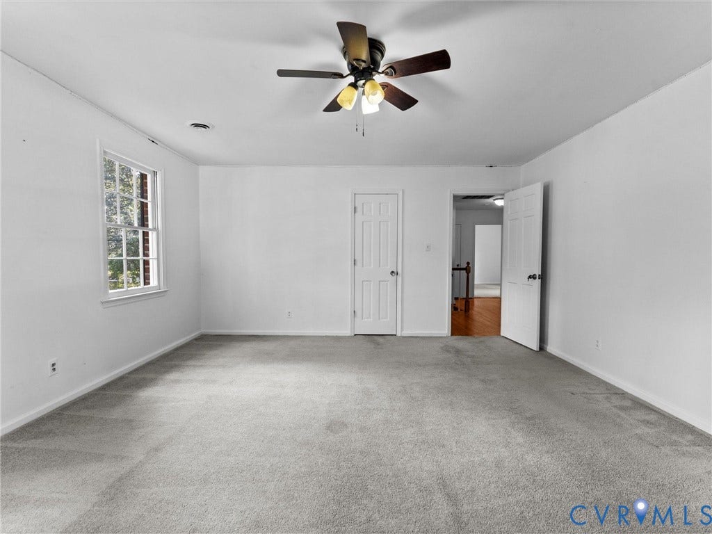 3610 Castlebury Drive, Chester, VA 23831 Spacious room with light gray carpeting, crisp white walls, a multi-pane window, and a ceiling fan with integrated lighting