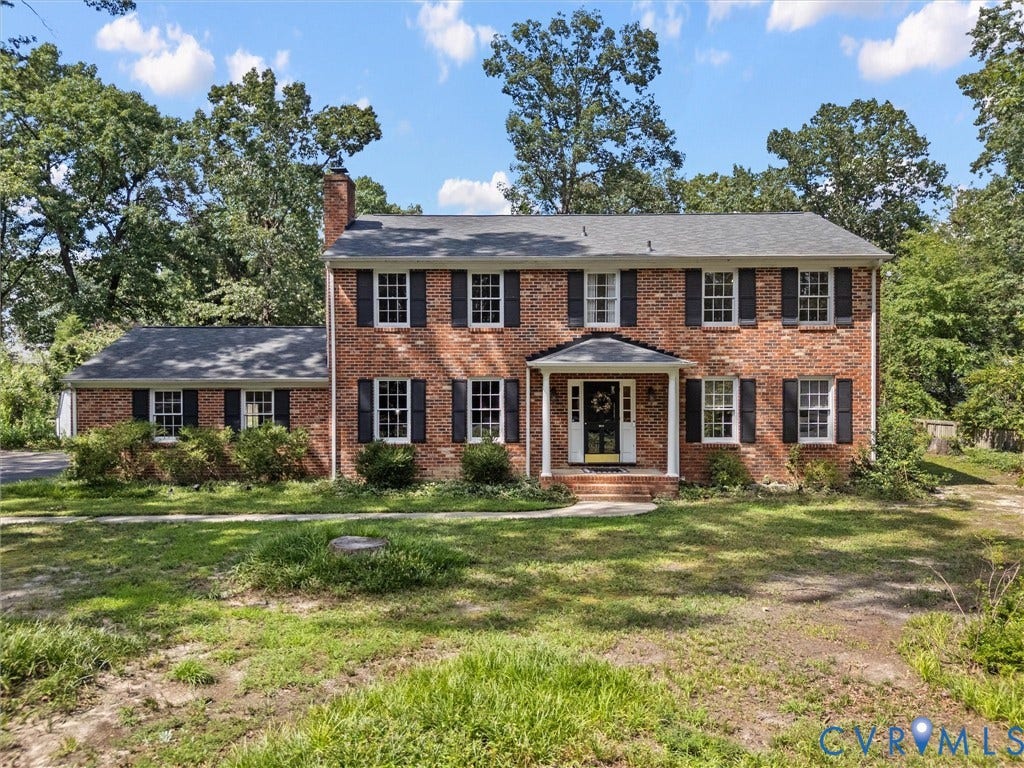 3610 Castlebury Drive, Chester, VA 23831 Brick facade residence featuring a covered entry, black shutters, and an attached single-story section