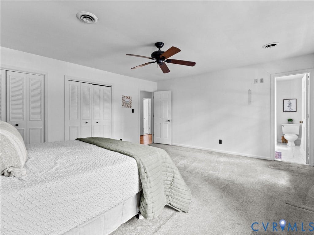 3610 Castlebury Drive, Chester, VA 23831 Spacious room featuring light gray carpeting, a ceiling fan with wood-finish blades, and white louvered closet doors