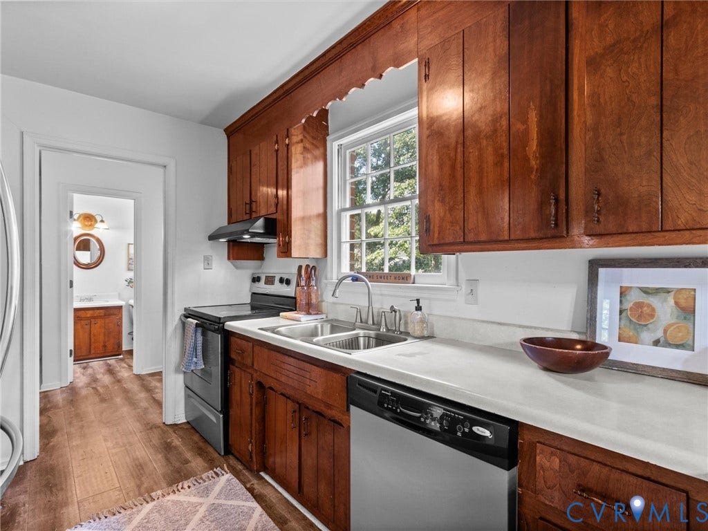 3610 Castlebury Drive, Chester, VA 23831 Wood-finish flooring, wood cabinetry, white countertops, dual basin sink, and stainless steel appliances