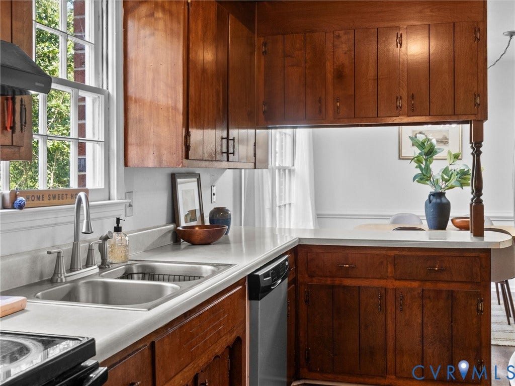 3610 Castlebury Drive, Chester, VA 23831 Wood-finish cabinetry, stainless steel double basin sink, and ample countertop space
