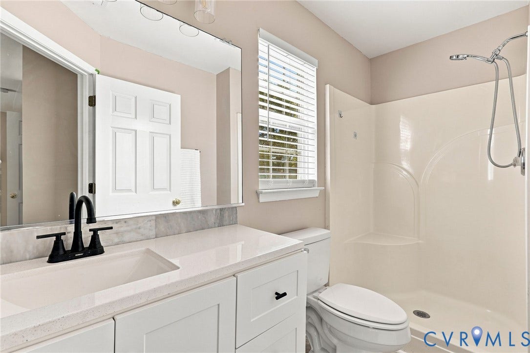 3818 Dominion Townes Circle, Dominion Townes, Richmond, VA 23223 White vanity with a single basin sink, matte black faucet, and stone countertop