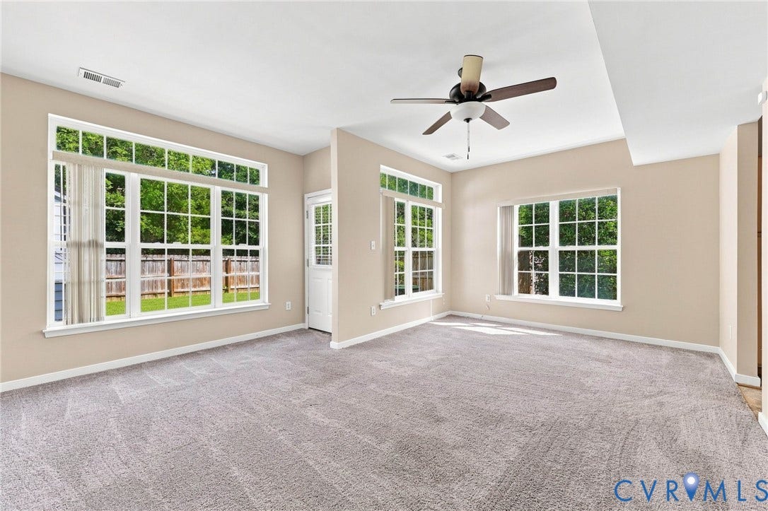 3818 Dominion Townes Circle, Dominion Townes, Richmond, VA 23223 Plush carpet flooring, multiple windows with white trim, and a ceiling fan with integrated lighting