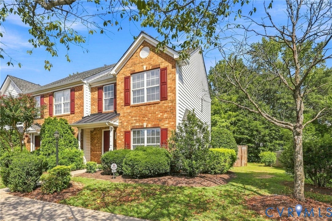 3818 Dominion Townes Circle, Dominion Townes, Richmond, VA 23223 Brick and siding exterior with red shutters, a gabled roofline, and mature landscaping