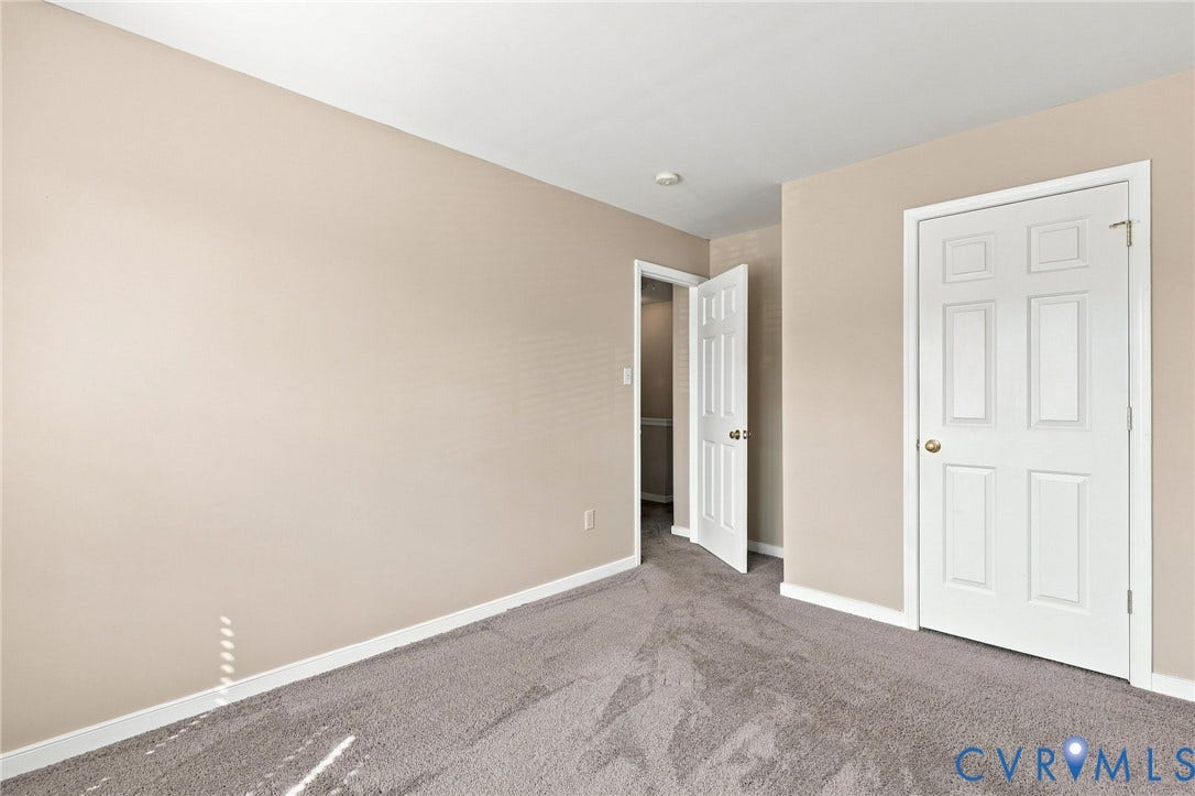 3818 Dominion Townes Circle, Dominion Townes, Richmond, VA 23223 Neutral tone wall paint, gray carpet, white trim, white six-panel door, recessed lighting.