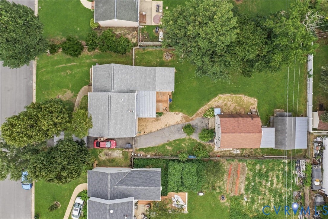 4013 Lawnwood Drive, Chesterfield, VA 23234 Property featuring a paved driveway, multiple structures, and mature trees on a spacious lot