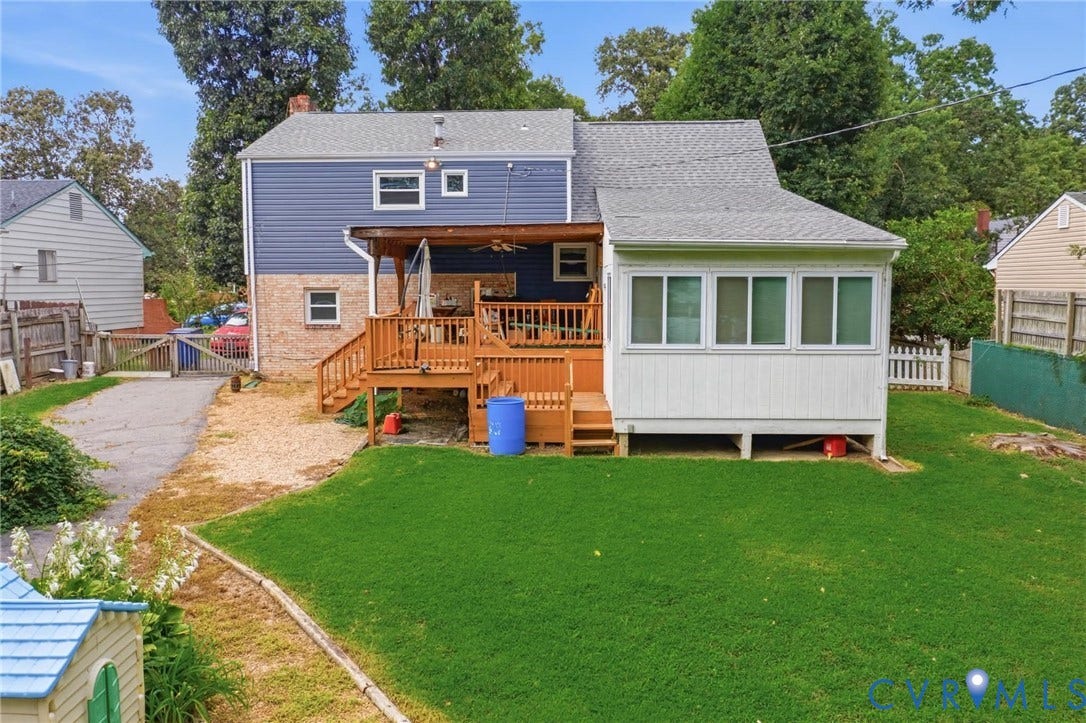 4013 Lawnwood Drive, Chesterfield, VA 23234 Expansive rear yard featuring a manicured lawn, a multi-level wood deck, a covered patio area, and a sunroom with multiple windows
