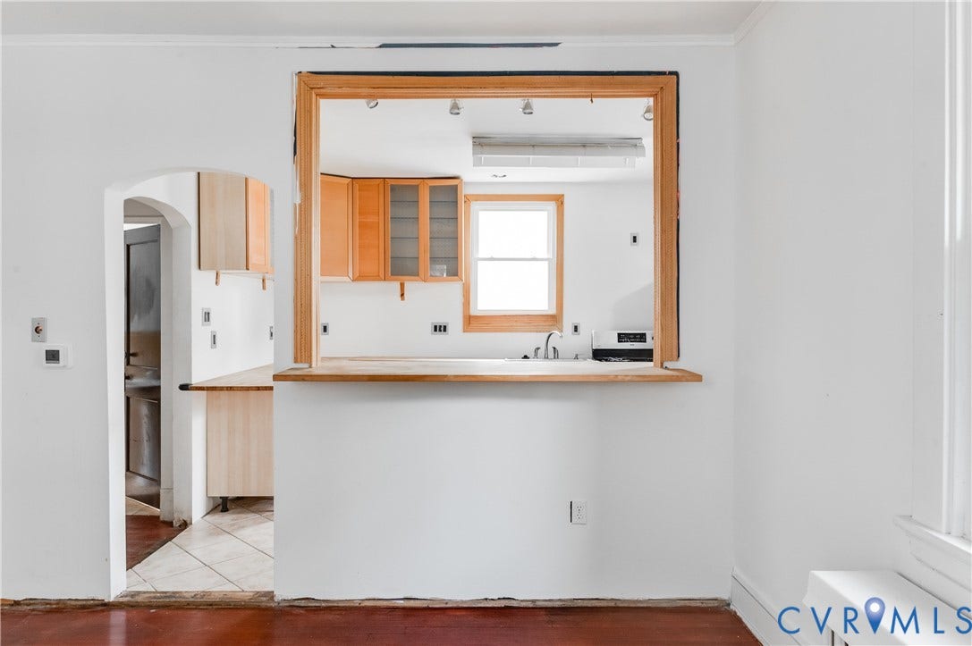 Pass-through opening with wood trim and wood-finish countertop