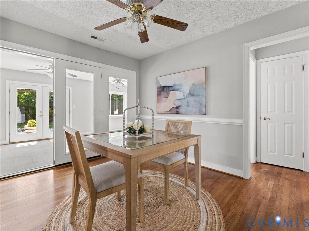 Charming space with ceiling fan, chair rail, hardwoods, and located in the center of the home