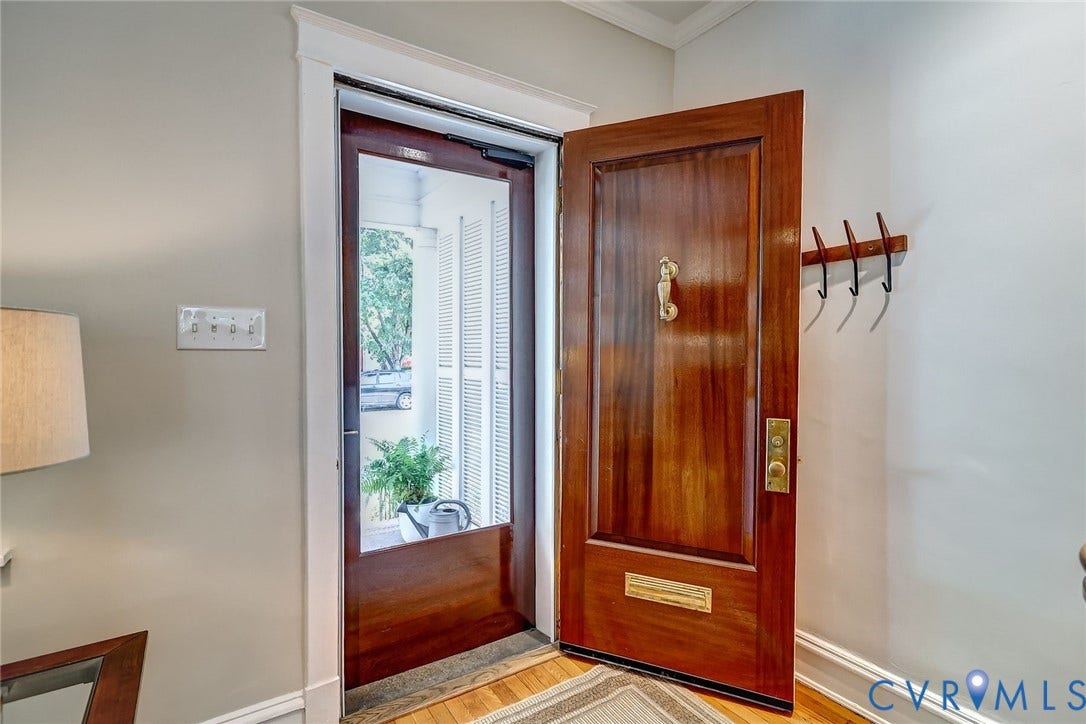 Custom-made mahogony door with glass and wood storm door.