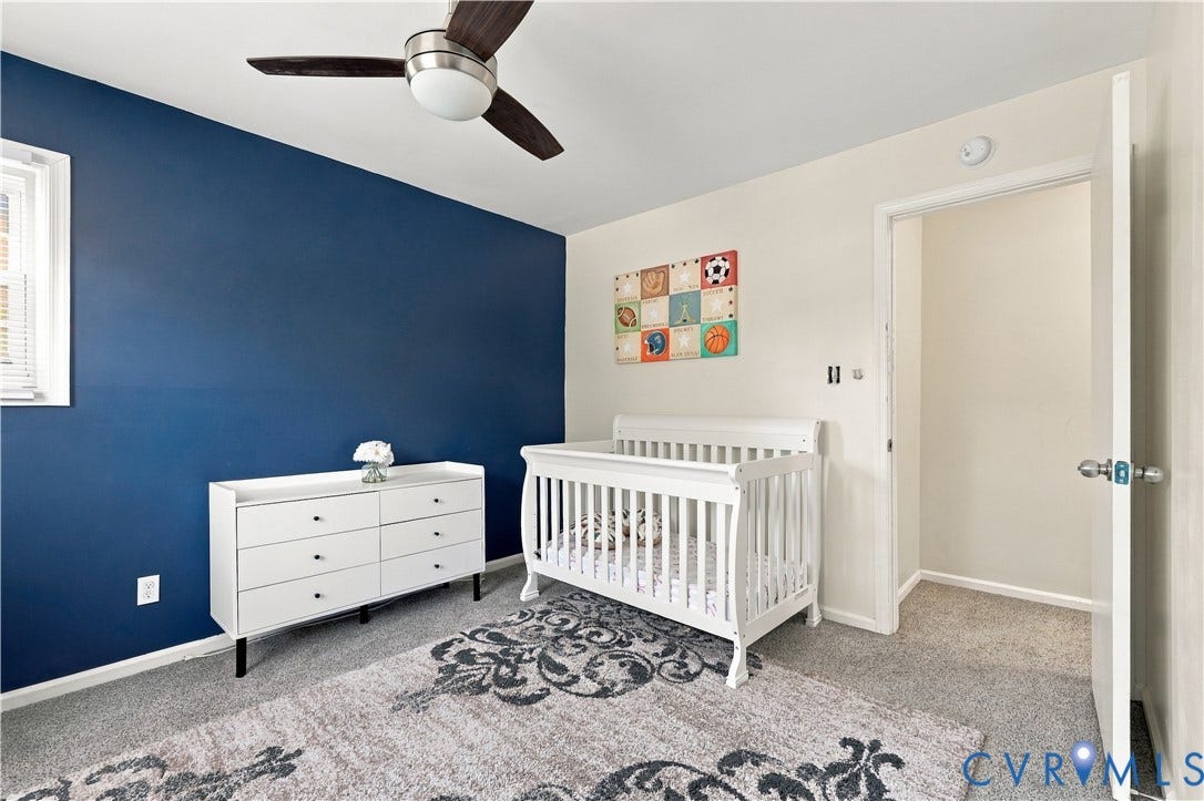 Plush carpeting, ceiling fan with light fixture, and a window with horizontal blinds