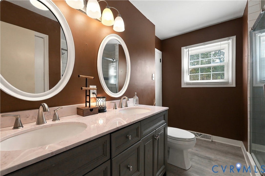 Dual vanity with integrated sinks, brushed nickel faucets, and a light-toned countertop