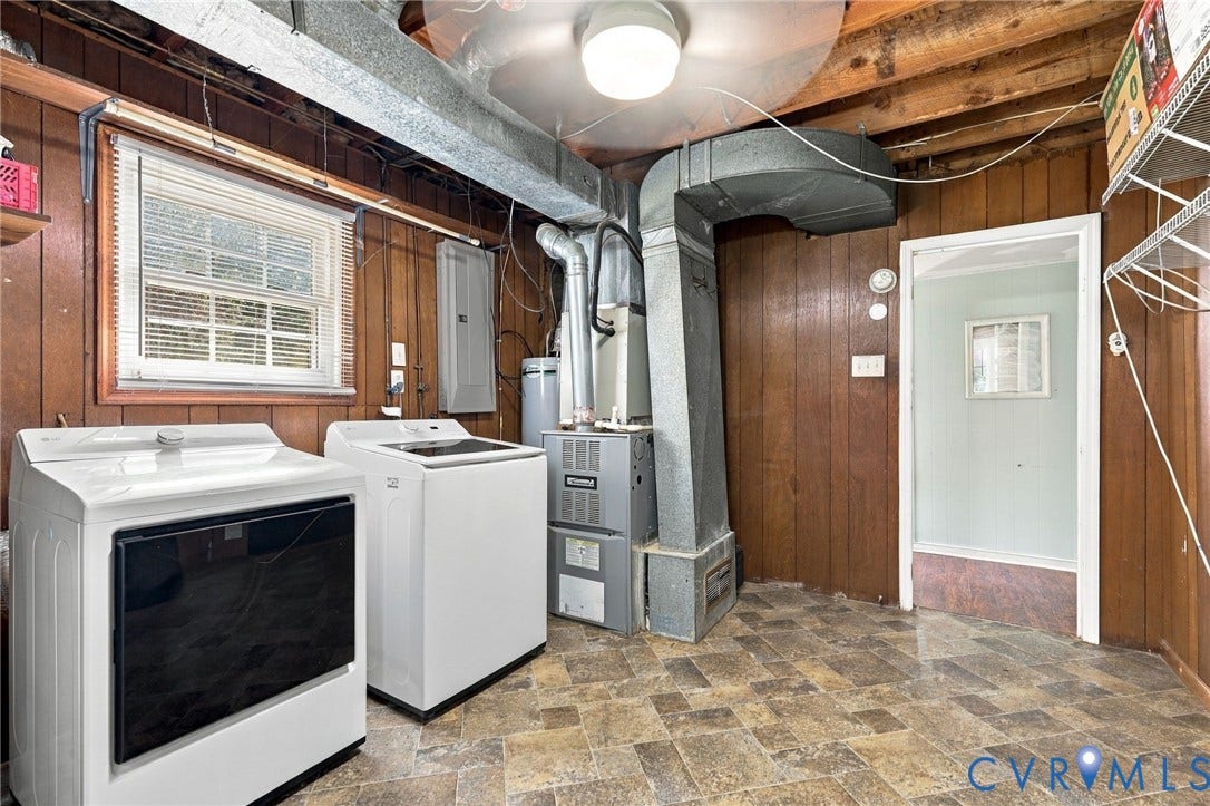 Utility room with wood-paneled walls and a window