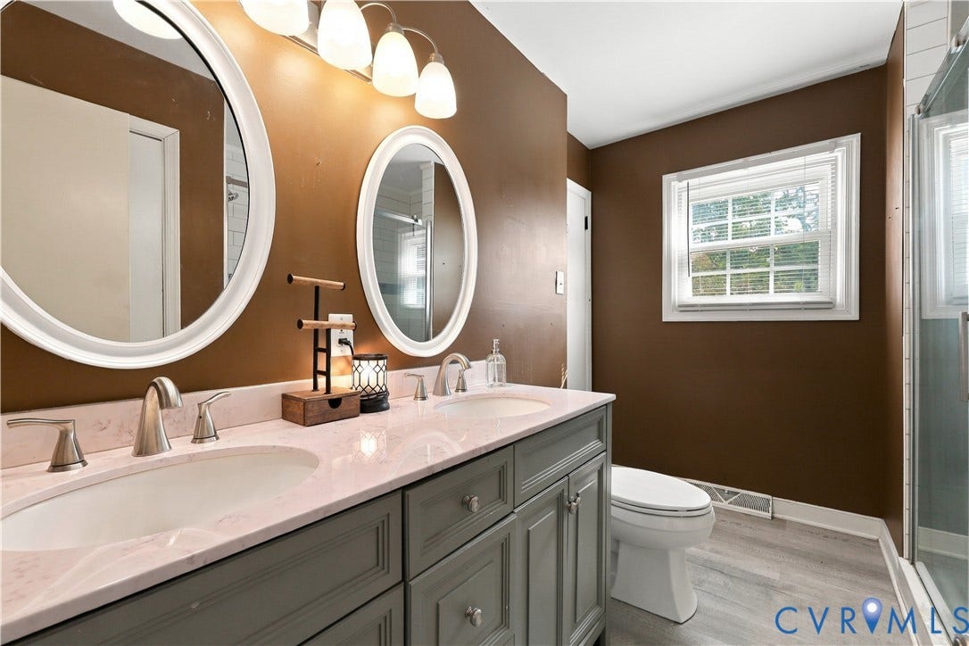 Dual vanity with undermount sinks, brushed nickel fixtures, and a light-toned countertop