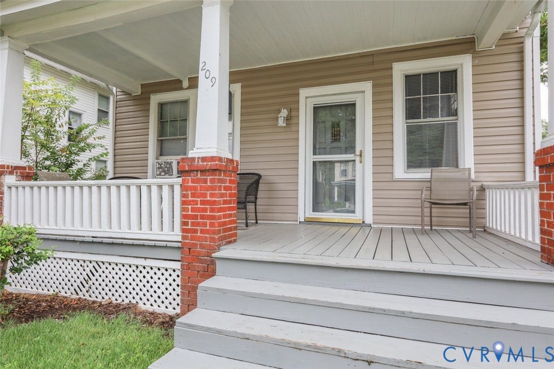 209 W 34th Street, Richmond, VA 23225 Front porch featuring a wood-finish deck, white railing, and brick columns