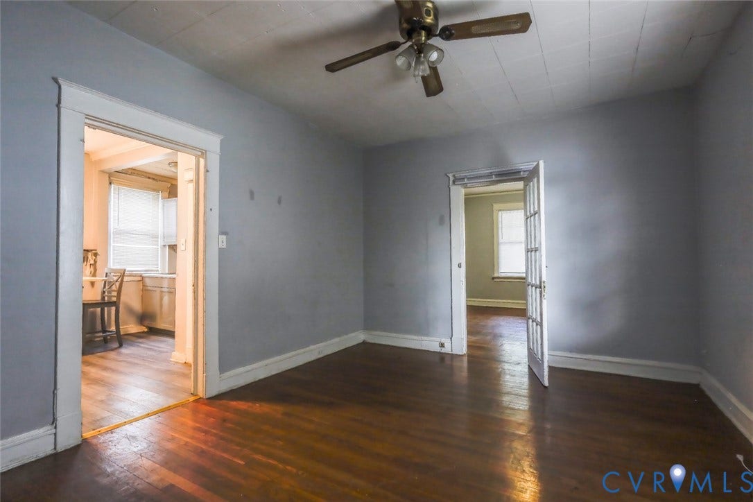 209 W 34th Street, Richmond, VA 23225 Wood-finish flooring throughout, ceiling fan with light fixture, and multiple doorways with trim