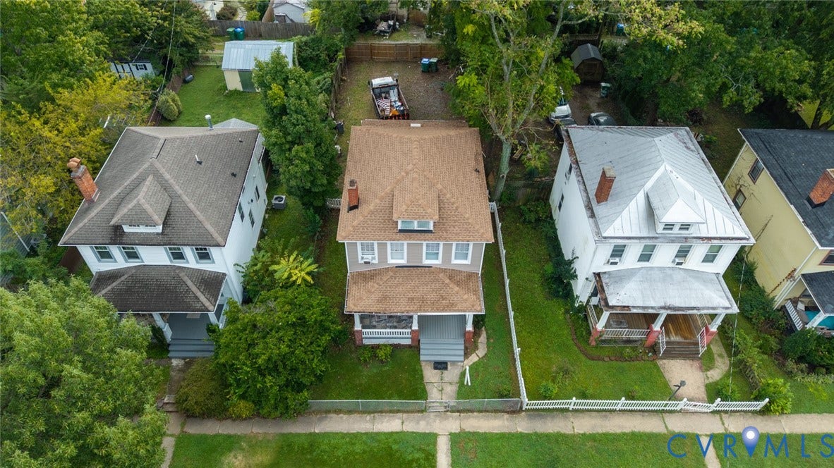 209 W 34th Street, Richmond, VA 23225 Traditional two-story residence featuring a covered front porch, a dormer window, and mature trees