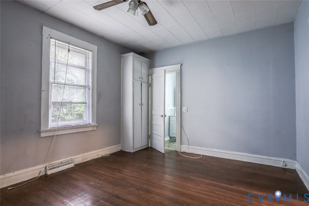 209 W 34th Street, Richmond, VA 23225 Hardwood flooring, ceiling fan, white trim, built-in storage, and a single window