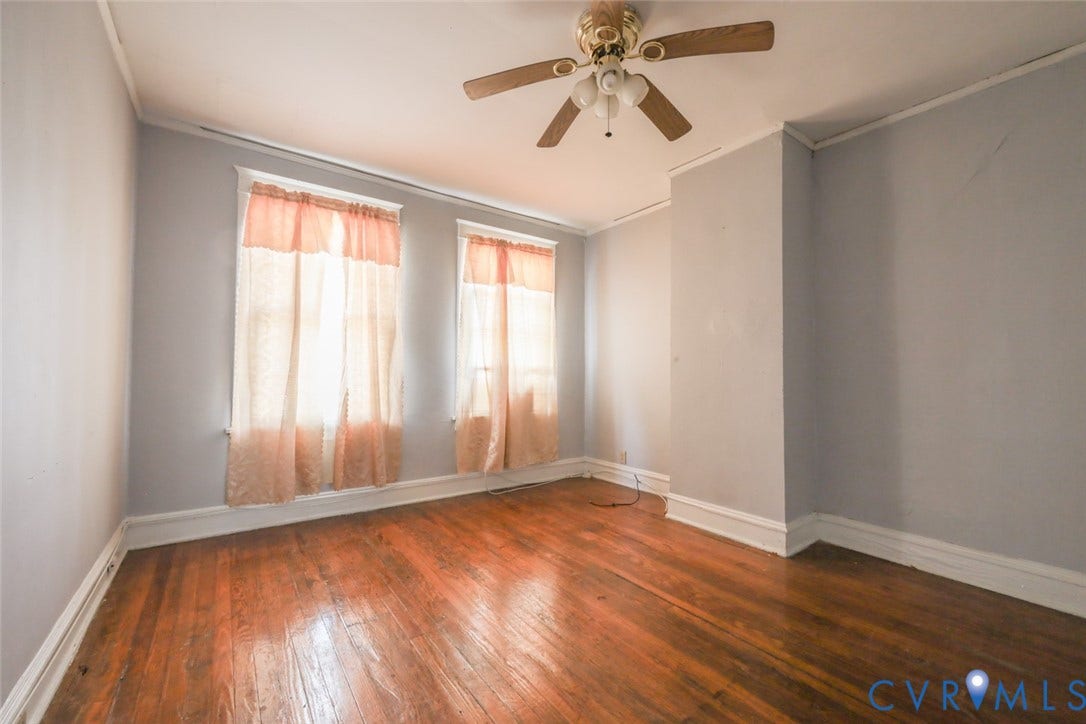 209 W 34th Street, Richmond, VA 23225 Hardwood flooring, painted walls, crown molding, two windows, and a ceiling fan
