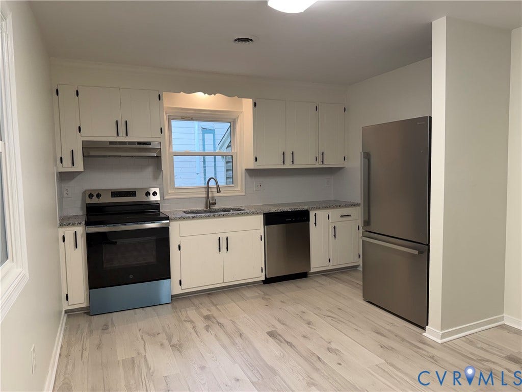 4706 Glen Tara Drive, Midlothian, VA 23112 White cabinetry with black hardware, stainless steel appliances, light-toned wood-finish flooring, and light-toned countertops