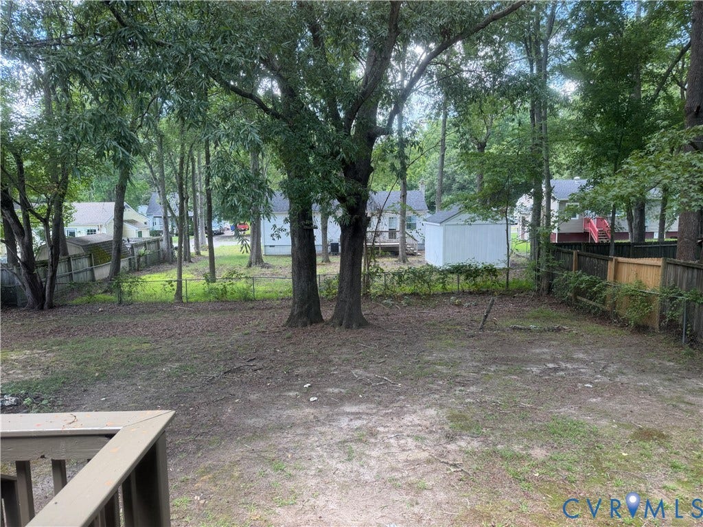 4706 Glen Tara Drive, Midlothian, VA 23112 Expansive backyard featuring mature trees, a privacy fence, and a dedicated storage shed