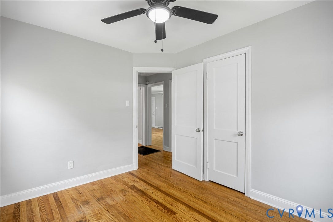 6710 Hanover Avenue, Westhampton Heights, Richmond, VA 23226 Hardwood flooring, light gray wall finishes, white trim, white paneled doors, and a ceiling fan with integrated lighting