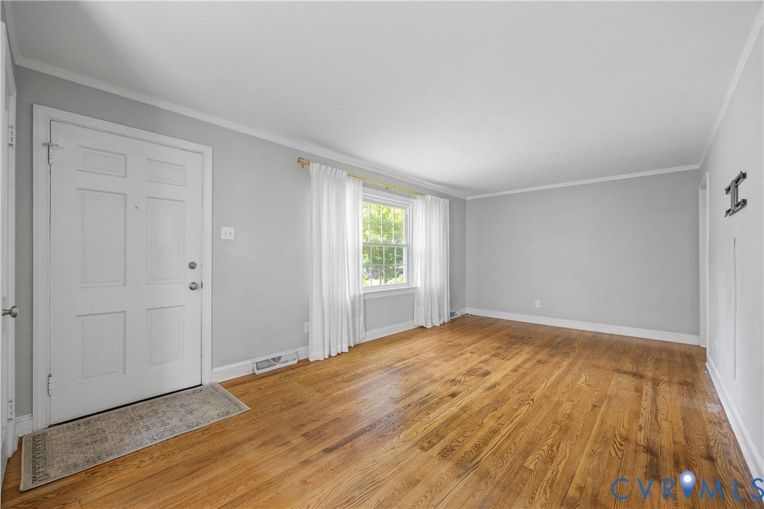 6710 Hanover Avenue, Westhampton Heights, Richmond, VA 23226 Hardwood flooring, painted walls, white trim, and a multi-pane window