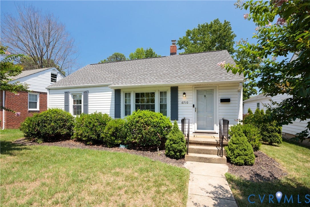 6710 Hanover Avenue, Westhampton Heights, Richmond, VA 23226 White siding exterior with grey shutters, a grey shingle roof, and a front entry with concrete steps and black metal railings