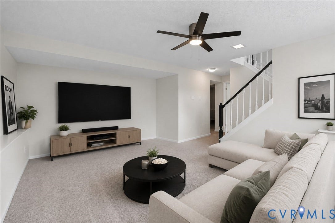 Recessed lighting, ceiling fan with integrated light, carpeted flooring, media console, and a staircase with white spindles and black handrail
